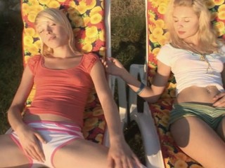 Two raunchy and brave blondes are masturbating their pussies outdoors